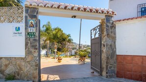 A gated entrance to a property named 'Casa Rural' with a stone wall and tiled roof. - Villa Jardin de Mari by Solset (Málaga)