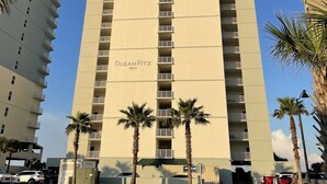 A tall, beige multi-story building with balconies, labeled "OceanRitz 10611". - TOP RATED / HUGE Balcony Beachfront 3 bed / 3 bath! (Panama City Beach)