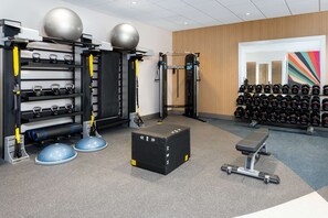 A gym with weightlifting equipment, kettlebells, and dumbbells. - Hilton Garden Inn Panama City Airport (Panama City)
