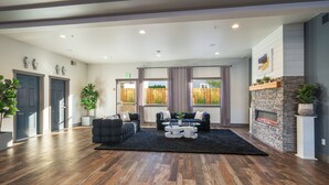 A modern lobby with a seating area, a fireplace, and a view of the outdoors. - The Lodge Lake Chelan (Manson)