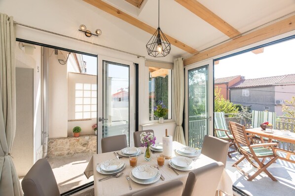 Enjoy meals in style with a beautifully set table for four, featuring fine china and elegant silverware.