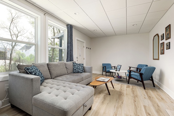 Unwind after a day of adventures in our cozy living room, complete with a sectional sofa and additional armchairs, providing a comfortable space for all guests.