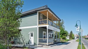 A two-story building with a porch, a sign reading 'Timberline Collection,' and a street lamp. - Juniper @ Timberline Flats​​​​​​​ (Traverse City)