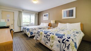 A hotel room with two beds, a desk, a chair, a window with curtains, and a door. - Toronto Lakeshore Hotel (Mississauga)