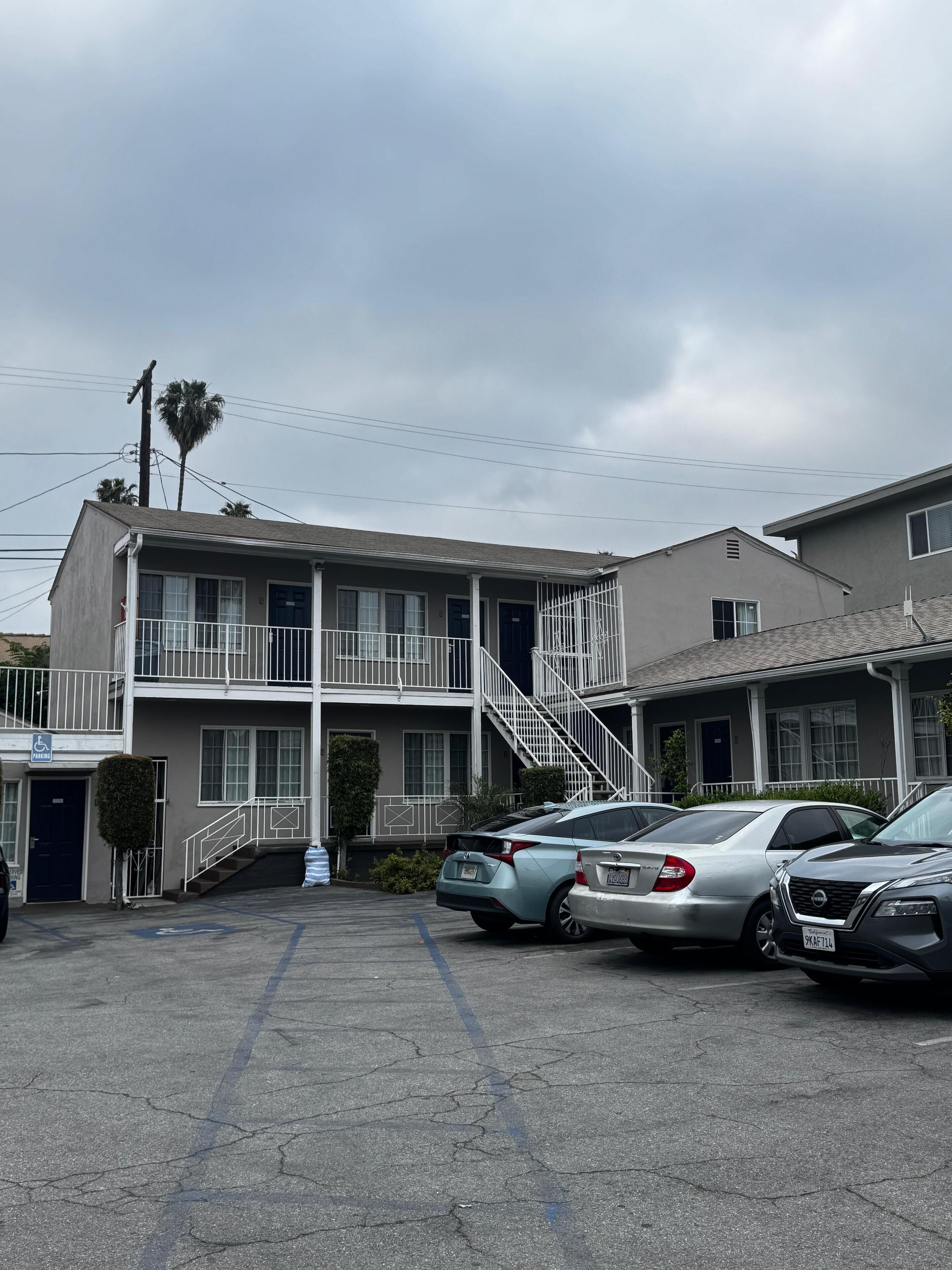 A two-story motel with a parking lot.