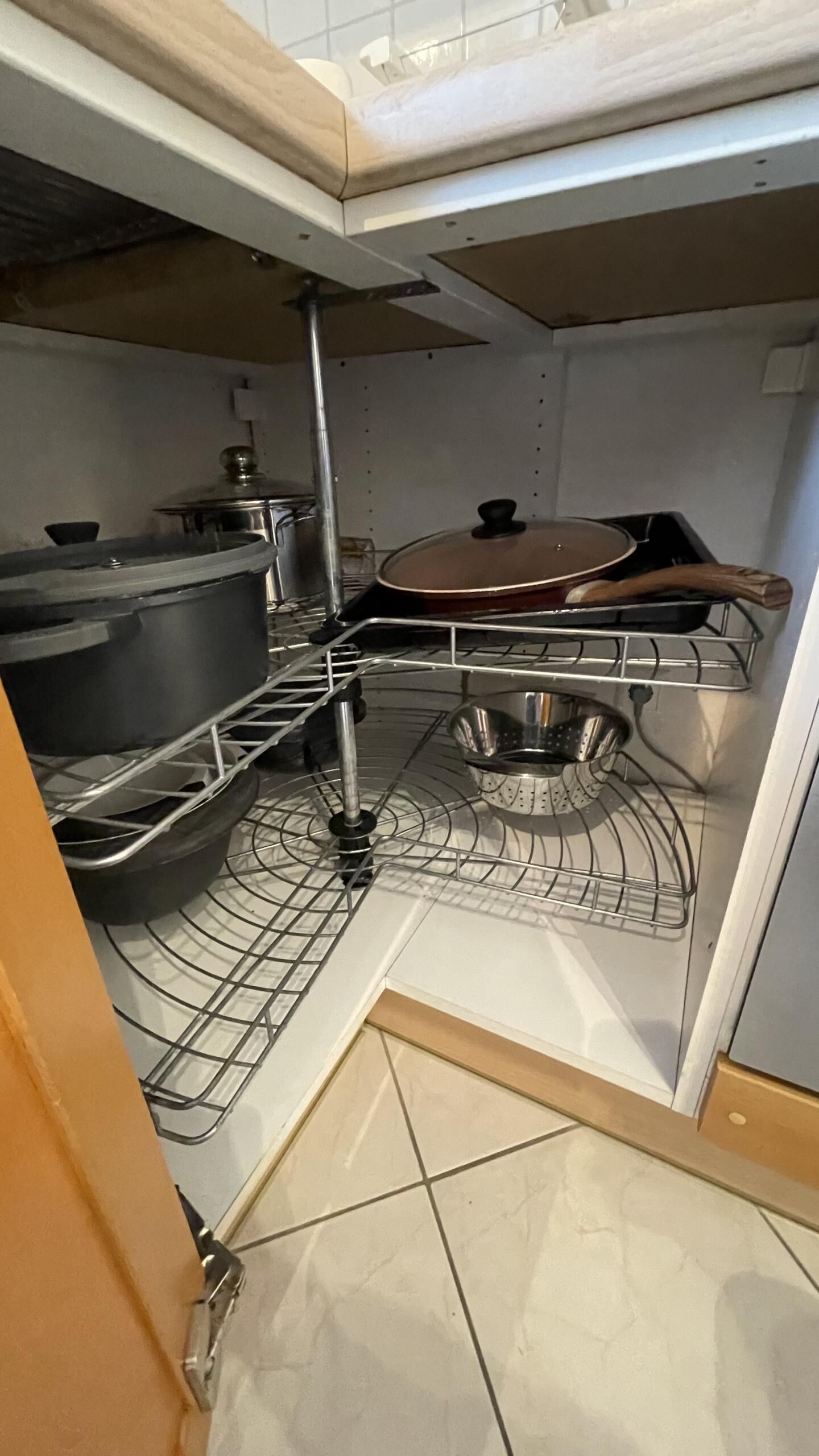 A kitchen with a built-in oven, a microwave, and a sink.