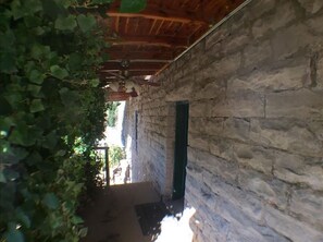 Leading to a door with a green frame, this corridor offers a glimpse into the property's interior.