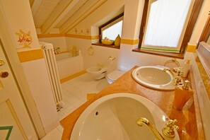 Bathtub, hair dryer, bidet, towels
