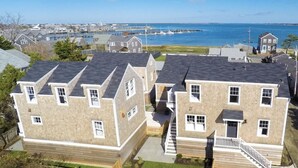 Un quartier résidentiel avec des maisons à deux étages, un escalier apparent et une vue sur la mer.