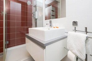 Shower, hair dryer, towels, shampoo