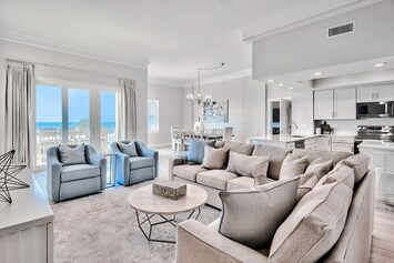 Open concept living room of 201A that leads into the kitchen with a sleeper sofa