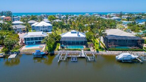 A coastal resort with multiple buildings, a marina, and a swimming pool.