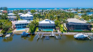 A coastal resort with multiple buildings, a marina, and a swimming pool.