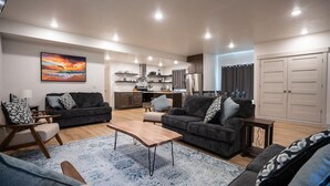 A modern living room with two sofas, a coffee table, and a dining area.