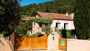 A rustic house with a tiled roof, a wooden gate, and a sign indicating a bed and breakfast. - Piscine Chauffée Privée - Parc Régional Naturel St (EVENOS)