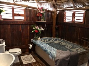 Bathtub, towels, soap, toilet paper