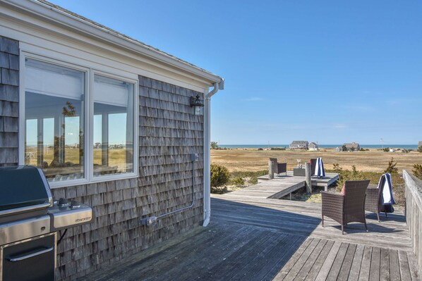 A deck with outdoor furniture and a barbecue grill.