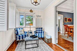 Relax in comfort with a cozy seating area, dining space, and natural views.