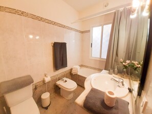 Un bagno con servizi igienici, bidet, lavandino e specchio.