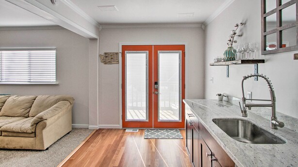 A kitchen with a double door, a sink, and a window with blinds. - Convenient Burien Getaway: 12 Mi to Dtwn SEA! (Burien)