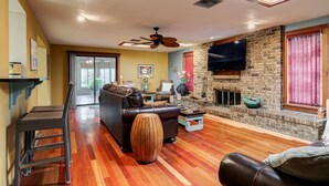 A living room with a fireplace, a television, and a sofa.