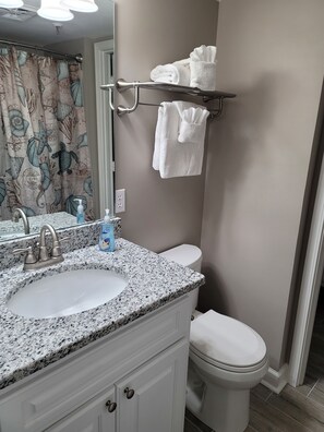 Combined shower/bathtub, towels, soap
