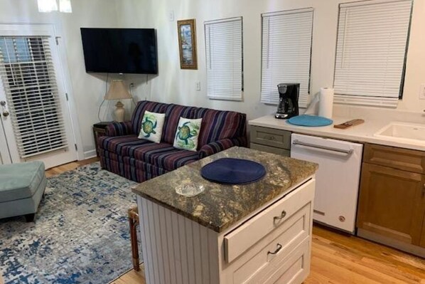 A compact kitchenette with a microwave, coffee maker, and a small sink.