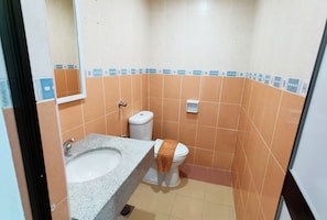 A bathroom with a sink, toilet, and a mirror. - Hotel Time Melaka (Malacca City)