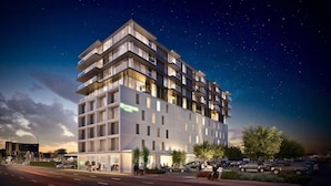 A multi-story hotel with a modern design, featuring balconies and large windows. - Wyndham Garden Christchurch (Christchurch)