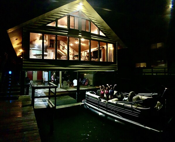 A multi-level house with a dock and boats. - Twin Cypress on False River (Oscar)