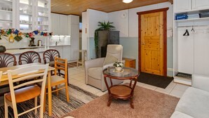 A cozy room with a dining area, a seating area, and a kitchen. - Kulma-alpit b by Interhome (Hyrynsalmi)