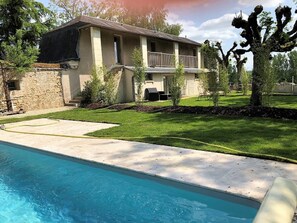 Enjoy a home with a balcony, lawn, and pool in a peaceful suburban setting.