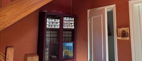 A wooden staircase with a glass display case below.