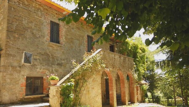 A rustic stone building with a brick roof, arched doorways, and a small garden area with a potted plant. - Casale Gli Angeli - Villa with Garden and Parking (Gubbio)
