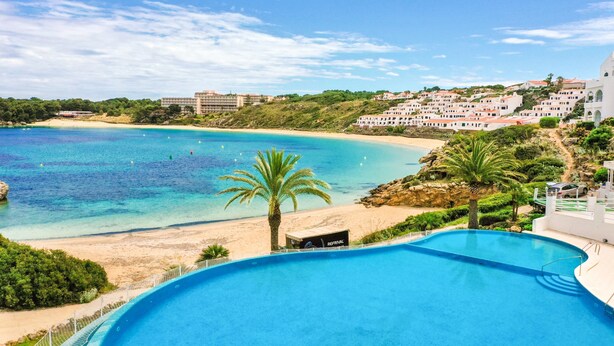 A resort with a swimming pool, beach, and ocean view. - Apartment "White Sands 306" on the Beach with Sea View, Pool (Arenal d'en Castell)