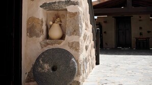 A stone wall with a large stone weight and a ceramic pot. - "Casa Rural Andresito" with Mountain Views, Pool, Wi-Fi, and Terrace (Pájara)