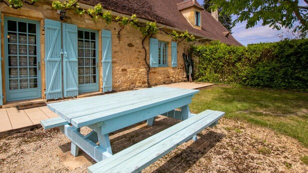 A rustic stone house with a tiled roof, a wooden bench, and a garden area. - House with shared jacuzzi and garden, near Dordogne (Saint-Avit-Rivière)