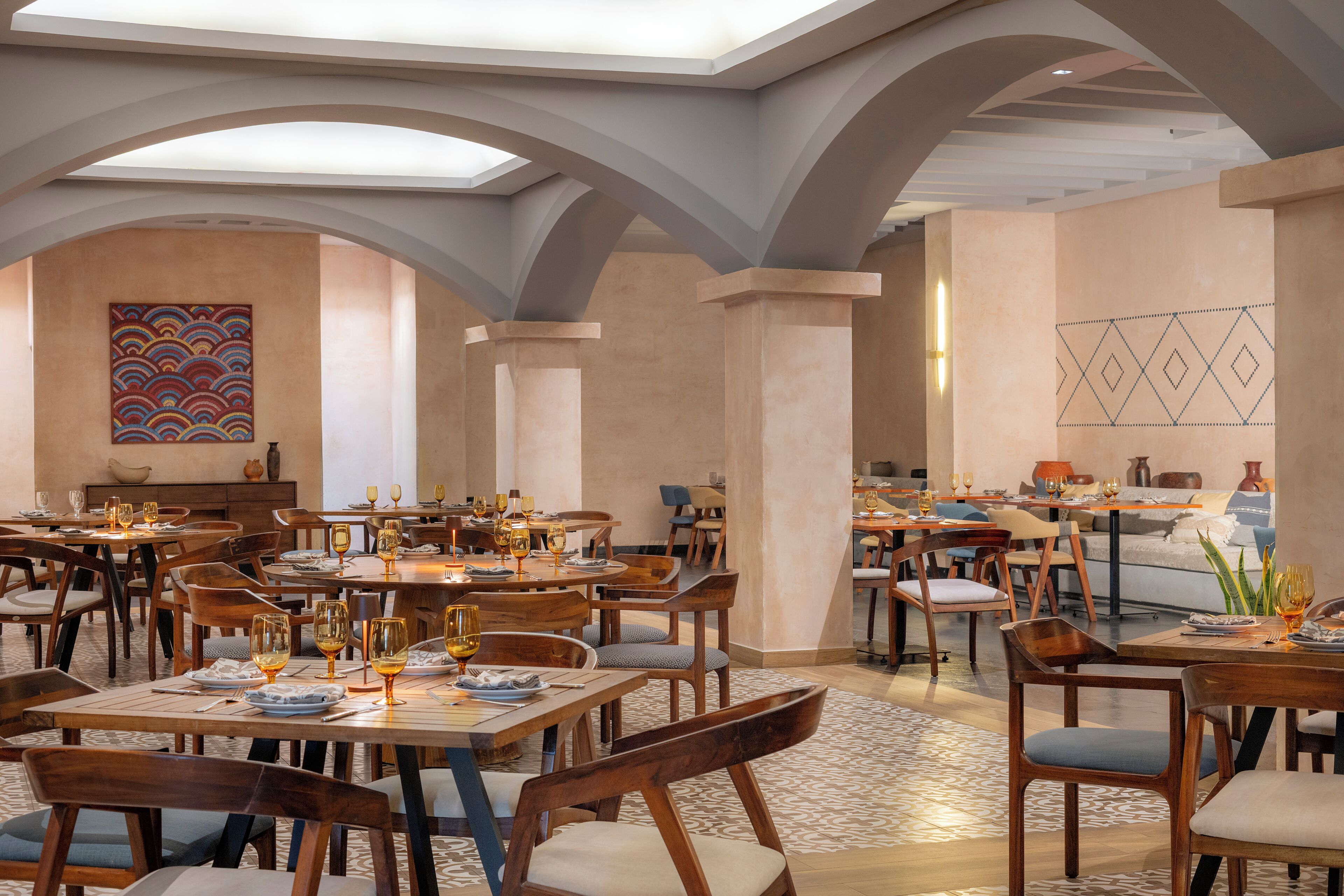 Restaurant dining room with arched ceiling details at Dreams Puerto Morelos Resort & Spa