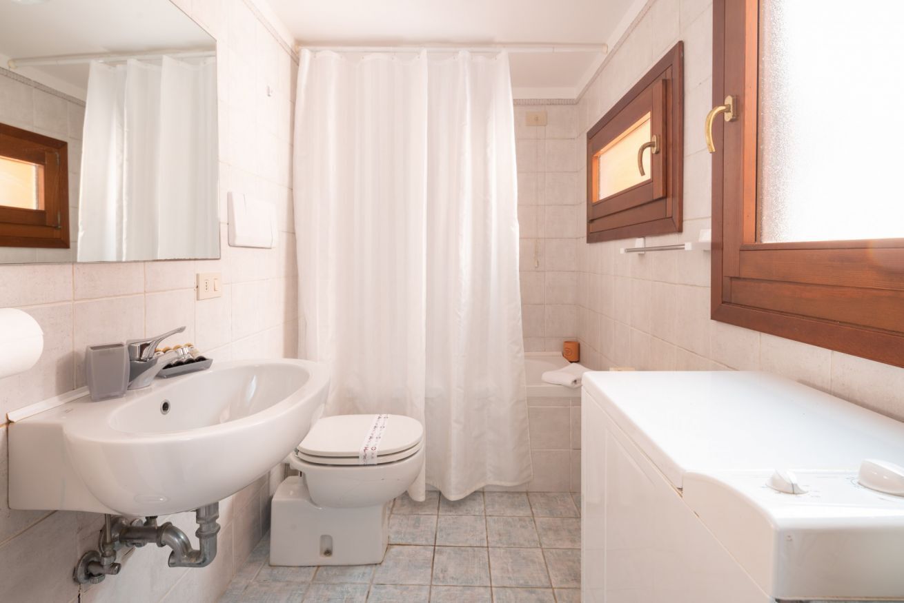 A bathroom with a sink, toilet, and bathtub.