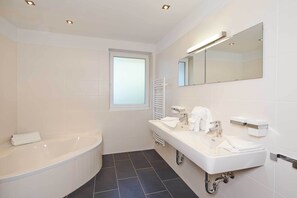 Bathtub, hair dryer, towels, soap