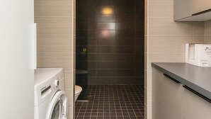 A modern bathroom with a washing machine, a toilet, and a sink. - Skivillas paljakka 1. (3mh) by Interhome (Puolanka)