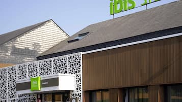 A building with a sign reading 'ibis Styles' and a logo.