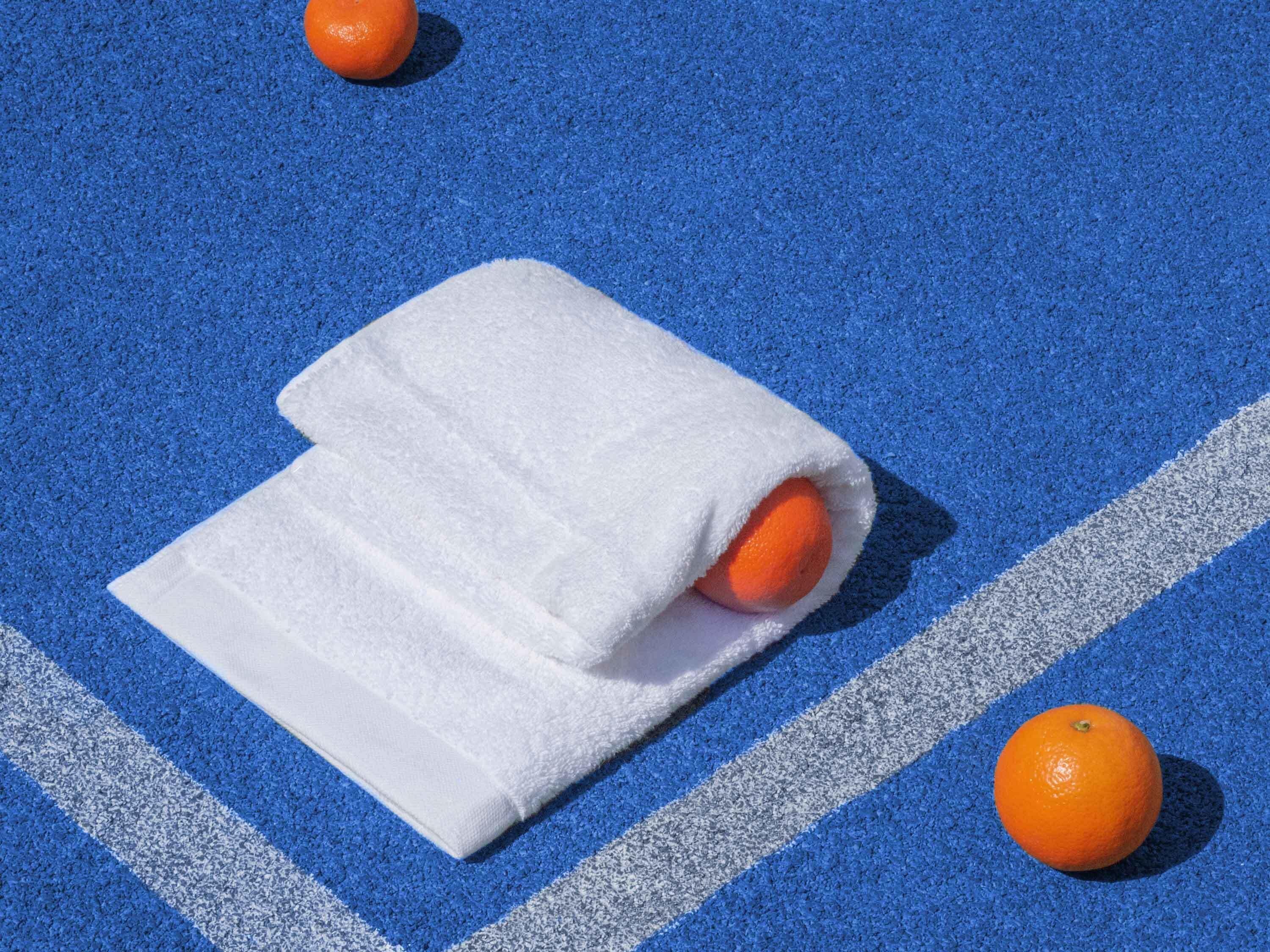 A blue parking space with a white towel and an orange.