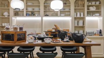 A breakfast buffet with various food items and a coffee machine.