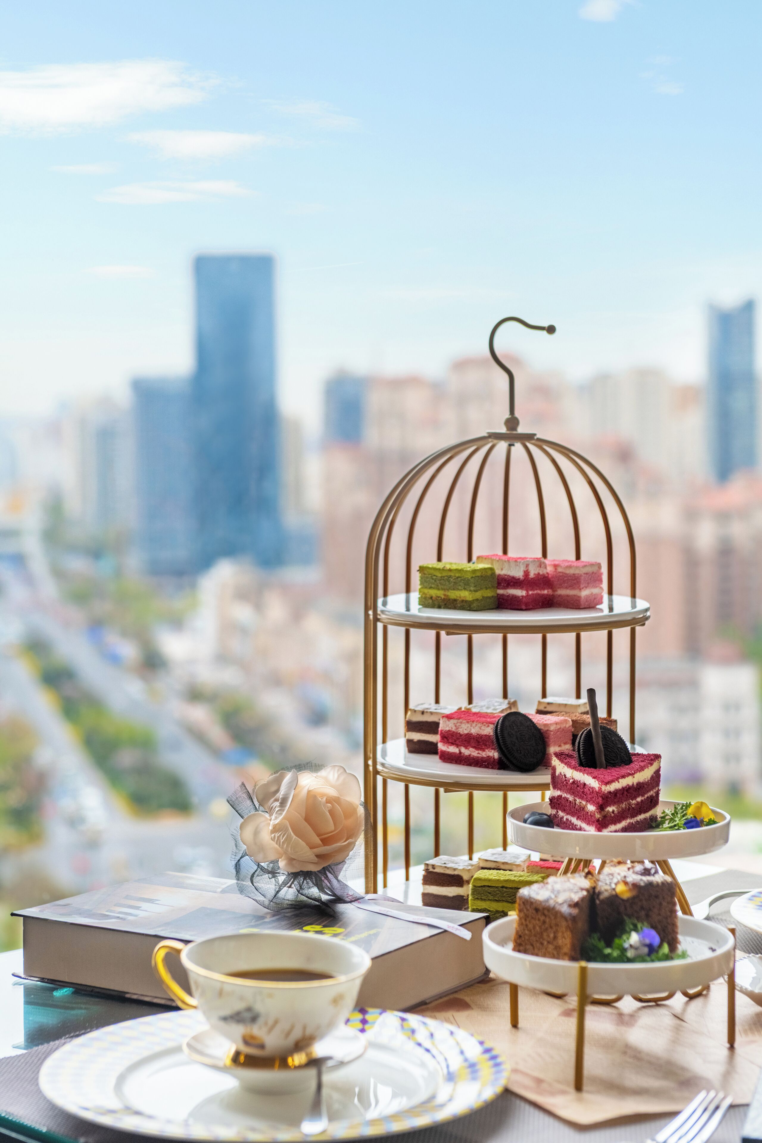 A dessert display with a cityscape view in the background.