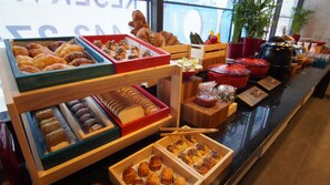 Un bufé con diversas opciones de panadería y salsas.