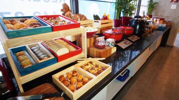 A buffet with various food items and kitchen equipment.