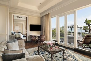 A spacious living room with a sofa, coffee table, and a flat-screen TV.