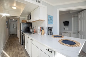 Fridge, microwave, stovetop, coffee/tea maker