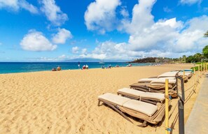 Relax on the beach with sun loungers and enjoy the marina views.